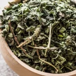 میزانی گزنه خشک خالص درون قاشق چوبی